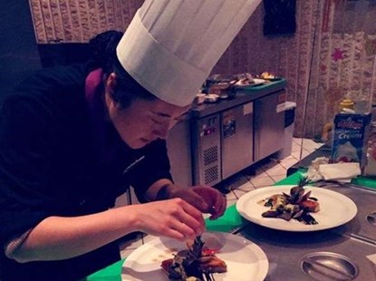 Chef arranging food on plates
